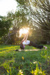 © leungchopan - Woman do yoga in green park at sunny day