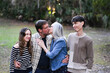© Cavan - Couple kissing while their children react with amused expression