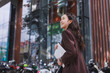 © crizzystudio - Young asian woman smiling walking with laptop working