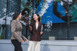© crizzystudio - Businesswomen discussing work outdoor smiling together