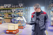© Grispb - Automated warehouse technician monitors robotic transport units with a laptop, overseeing cargo movement and ensuring efficient operation of smart logistics systems.