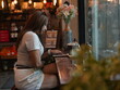 © sittinan - woman relax in cafe and use smartphone