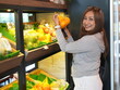 © sittinan - young woman holding a bag full of fruit