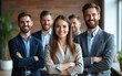 © handong - Smiling business people looking at camera and posing in office. Confident businesspeople standing with their arms crossed. Business colleagues and team concept. Front view. High quality