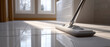 © perfectlab - Close-up of a mop cleaning shiny white tiled floor in a bright room with large and natural sunlight