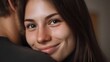 © Thares2020 - A beautiful young woman with dimples smiles warmly while being embraced conveying happiness love and deep connection