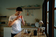© Prathankarnpap - A man enjoying coffee cup in a kitchen room in the morning