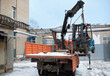 © Rystemys - Loading a forklift onto a truck, crane, carrier, manipulator with a boom. Forklift hanging in the air on the boom of a crane