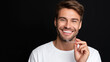 © OleksandrZastrozhnov - Young caucasian male smiling with clear aligners on black background