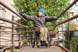 © Alex - a man in a wheelchair descends a ramp
