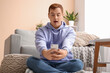 © Pixel-Shot - Young man with mobile phone taking selfie on floor at home