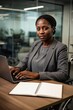 © Aliaksandr Barouski - Black woman in wheelchair working on laptop at desk in modern office today
