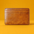 © alexandre - brown leather wallet for cards on yellow background