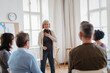 © Halfpoint - Older woman speaking about her success during guided therapeutic session.