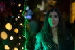 © FotoAndalucia - Informal Portrait of a Woman Looking at Christmas Lights in a European City on a Winter Night
