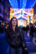 © FotoAndalucia - Informal Portrait of a Woman Looking at Christmas Lights in a European City on a Winter Night