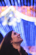© FotoAndalucia - Informal Portrait of a Woman Looking at Christmas Lights in a European City on a Winter Nigh