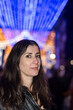 © FotoAndalucia - Informal Portrait of a Woman Looking at Christmas Lights in a European City on a Winter Night