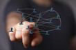 © vegefox.com - Abstract conceptual image of social networking and business connections. Hand pointing at a network of interconnected people symbolizing communi