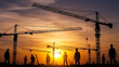 © fahri - A construction site at sunset, featuring silhouetted workers and cranes against a vibrant orange and yellow sky. The image captures the essence of industrial activity during the golden hour.