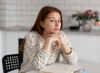 © tan4ikk - Thoughtful Teen Girl Dreaming At Home While Sitting At The Table