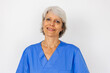 © Xavier Lorenzo - Portrait of confident middle aged female doctor in blue uniform looking at camera over white background