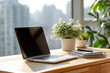 © krasyuk - Workspace with laptop, notepad, and plants in a sunlit room during afternoon hours