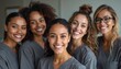 © Vadym - Five smiling women in grey scrubs pose together in a bright room. They are a diverse group of dental assistants happy to provide dental care and service.