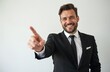 © Vadym - Man in black suit points finger forward. Smiling person with happy expression gives positive energy. Guy indicates direction, shows choice, makes decision on light background.