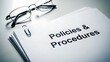 © Musfiqur - Stack of policies and procedures documents with reading glasses and paperclip nearby