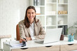 © Pixel-Shot - Young businesswoman working at desk in office