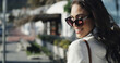 © peopleimages.com - Smile, travel and sunglasses with portrait of woman in city for confidence, trip and vacation. Happiness, pride and eyewear style with person walking outdoor for holiday, relax and positive attitude