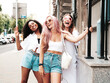 © halayalex - Three young beautiful smiling hipster female in trendy summer clothes.Sexy carefree multiracial women posing on the street background.Positive models having fun in sunglasses. Cheerful and happy