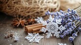 Delicate lace snowflakes lying on a table beside dried lavender and cinnamon bundles. .