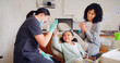 © Kobus L/peopleimages.com - Child, high five and dentist for consultation with discussion, oral hygiene and mouth cleaning service. Mother, health professional and orthodontic inspection for dental care with girl for checkup