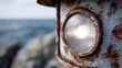 © SashaMagic - Close-up of a rusty lighthouse by the ocean.