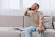© SHOTPRIME STUDIO - Laughing man on a phone call, embracing soft masculinity and male vulnerability while enjoying a solo living moment in a cozy environment.