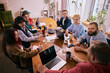 © master1305 - Creative coworkers brainstorming together around office table. Concept of idea generation, collaborative thinking, teamwork energy and modern coworking office culture.