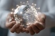 © Iftikhar alam - Hands hold a transparent globe showcasing continents with glowing connections symbolizing global networking and communication