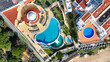 © AmazingAerialAgency - Aerial view of turquoise pools contrast with terracotta roofs and golden sands, a vibrant tapestry of leisure and architecture, Albufeira, Faro District, Algarve, Portugal.