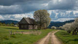 Rustic wooden farmhouse sits beside a dirt path leading through a vibrant green meadow under dramatic spring skies