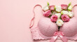 © smth.design - Lace pink bra filled with fresh roses and eustoma flowers on pastel background symbolizing femininity romance and intimate elegance