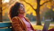 © Viktor - Woman relaxes on park bench with laptop, enjoys autumn sunlight and fresh air. She takes a peaceful break, breathing deeply, feeling calm and happy. A moment of solitude and joy outdoors.