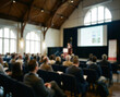 © gankevstock - Speaker presents to an audience at a conference in a lecture hall