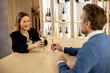 © BGStock72 - Couple enjoying drinks at wine bar during evening gathering with elegant decor