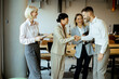 © BGStock72 - Business people shake hands during a meeting in a modern office space