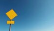 © Maryna - Blank yellow diamond traffic sign with rectangular plate below mounted on pole against clear blue sky. Roadside marker alerts drivers to upcoming road conditions or hazards.