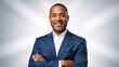© Vasiliy - Confident smiling african american businessman with arms crossed. Professional male executive in a blue suit posing for a corporate headshot in a studio