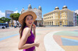 © zigres - Tourism in Recife, Brazil. Traveler woman visiting Marco Zero Square in the historic center of Recife, Brazil.