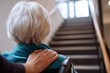© Prazis Images - Caregiver's Hand on Senior's Shoulder Facing a Staircase Challenge
